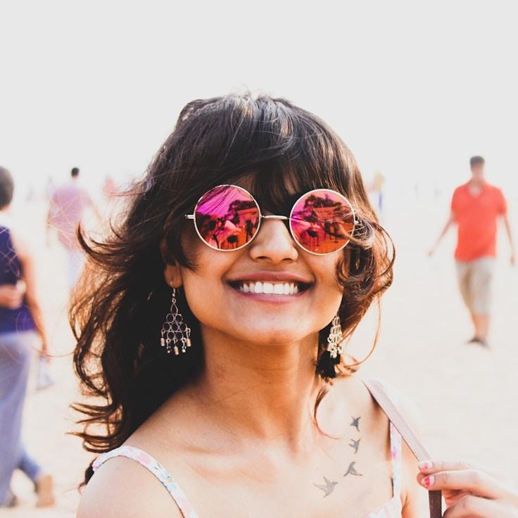 Kaveri Mehta, Lead Design Curator at GrovePineCrestOakWood, reviewing corporate floral arrangements